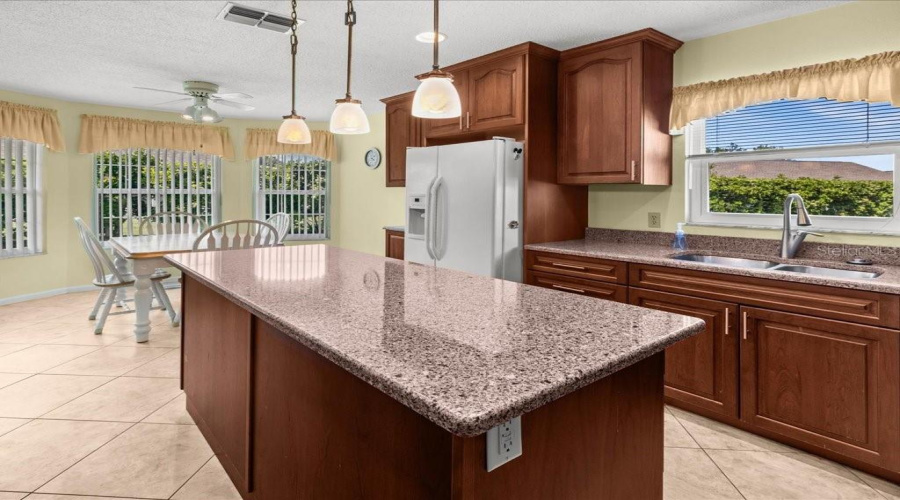 Bright And Inviting Kitchen Filled With Natural Light, Highlighting Clean Finishes And Warm, Welcoming Atmosphere.
