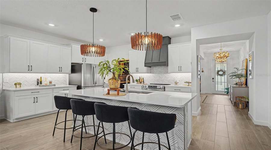 Large Kitchen With Quartz Countertops And Large Island
