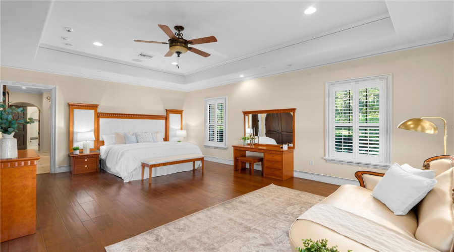 The Expansive Primary Bedroom Offers An Atmosphere Of Understated Luxury With Hardwood Flooring, Refined Architectural Details And Generous Space For A Private Sitting Area.