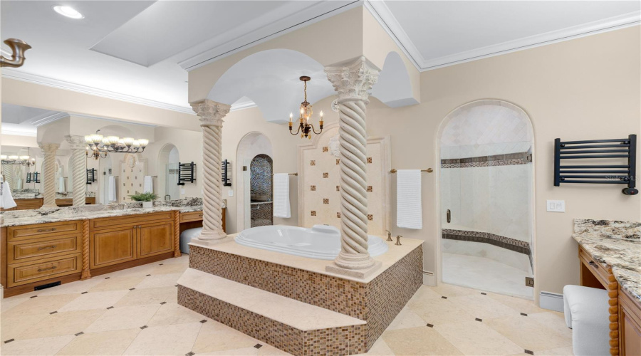 Resort-Level Luxury Defines This Primary Bath, With An Elevated Jacuzzi Tub, Sculptural Columns, Custom Cabinetry And An Exceptionally Generous Spa-Like Layout.