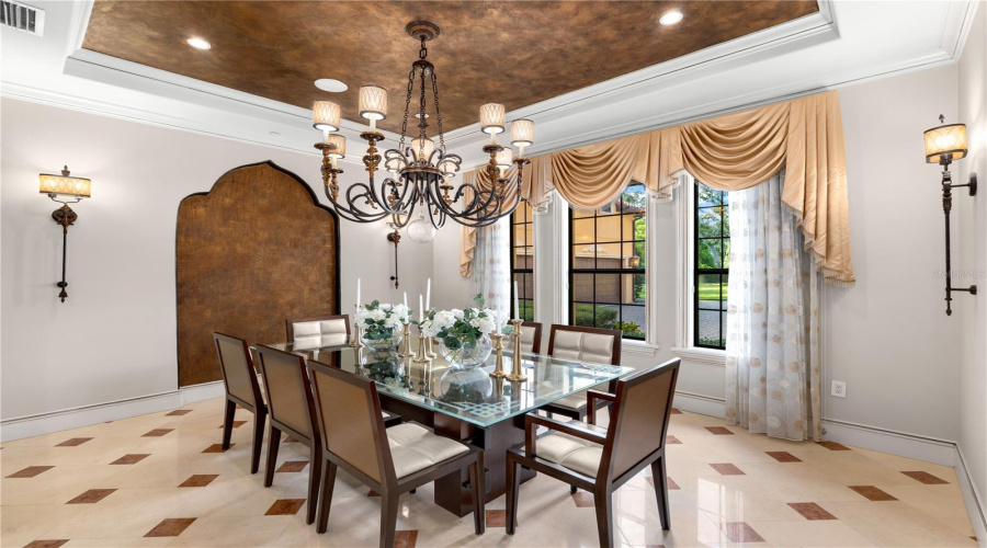 A Striking Formal Dining Room Is Crowned By A Dramatic Chandelier And Custom Ceiling Treatment, Designed As An Elegant Backdrop For Memorable Entertaining.