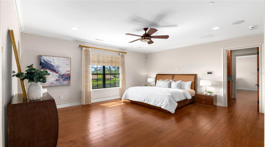A Second Primary First-Floor Bedroom Offers Hardwood Flooring, A Tray Ceiling And Private En-Suite Accommodations, Reflecting This Lake Mary Estate'S Attention To Comfort And Craftsmanship.