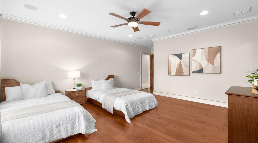 A Generously Scaled Third Bedroom Offers Hardwood Flooring, A Tray Ceiling And A Private En-Suite Bath — Refined Accommodations For Family Or Guests.