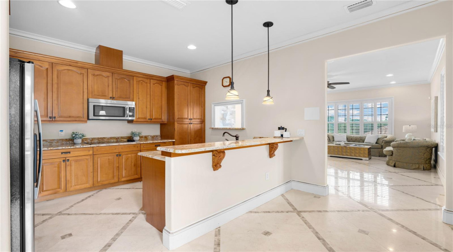 The Kitchen Of The Third-Floor Private Guest Apartment, Complete With Wood Cabinetry, Refrigerator, Stove Top, Microwave, And A Breakfast Bar Is Ideal For Guests And Extended Stays.