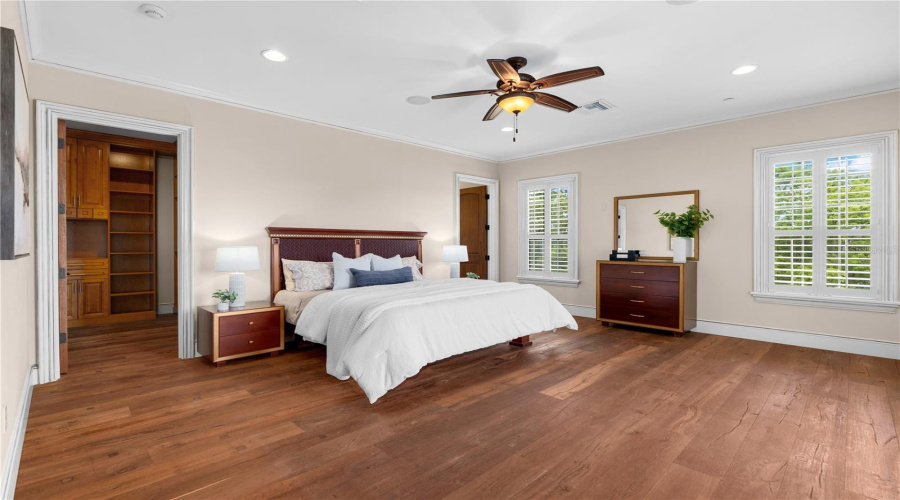 A Beautifully Scaled Guest Residence Bedroom With Hardwood Flooring, Tray Ceiling And Generous Natural Light Offers Refined Accommodations Apart From The Main Residence.