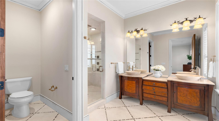 The Guest Residence Bath Features A Generous Dual Vanity With Wood Cabinetry And Bright, Timeless Finishes.