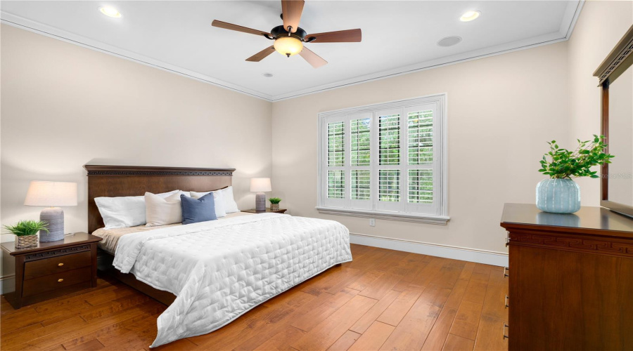 A Second Guest Residence Bedroom With Hardwood Flooring And A Tray Ceiling Offers Comfortable, Beautifully Appointed Private Accommodations.