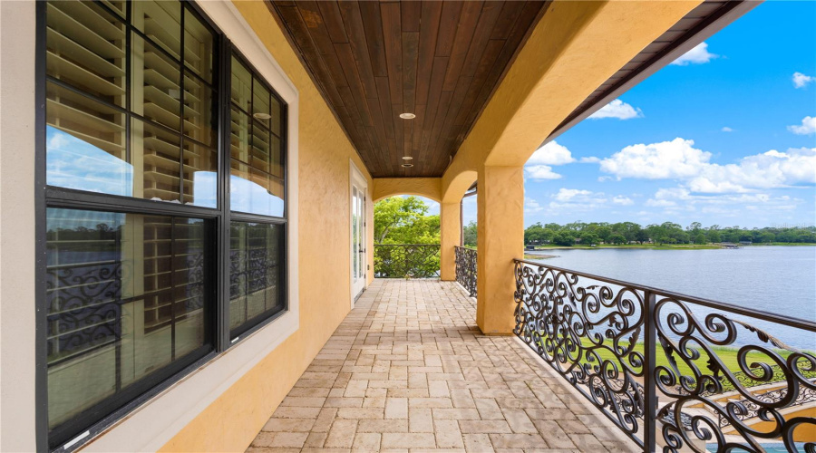 The Lake-Facing Covered Balcony Captures Tranquil Views Across Lake Mary, An Exceptional Setting For Morning Coffee Or Sunset Relaxation.