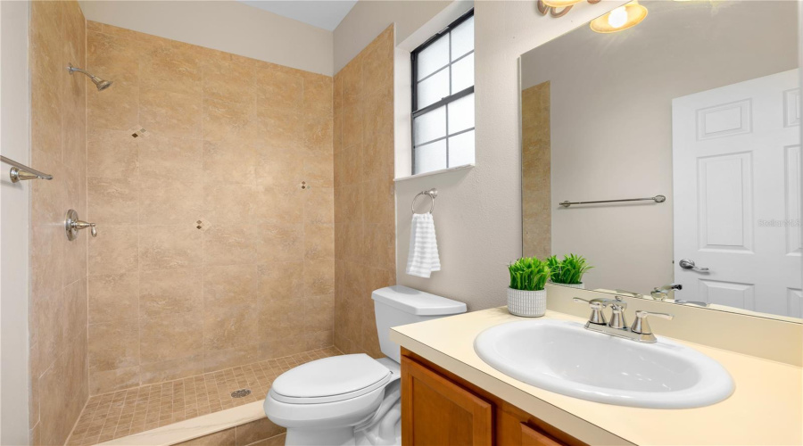The Garden Apartment'S Private Bath Features A Walk-In Shower, Vanity And Natural Light, Completing This Independently Situated Living Accommodation.