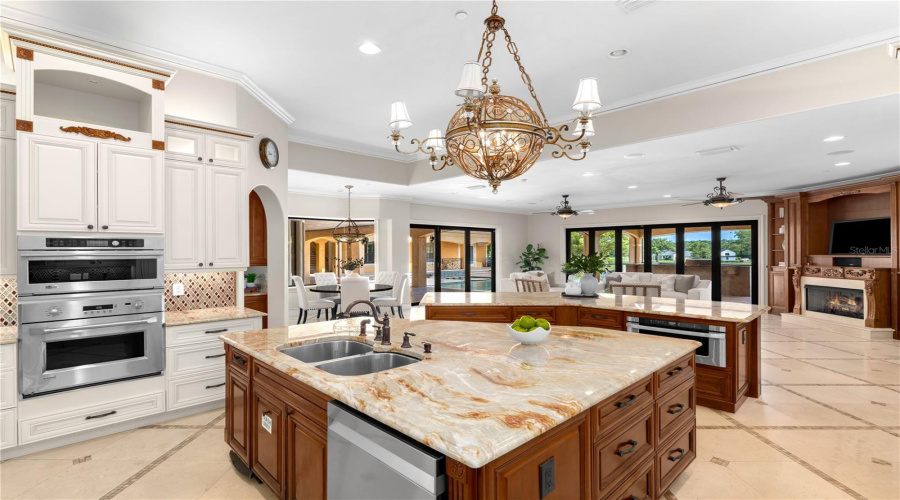 A Showpiece Chef'S Kitchen Anchored By A Substantial Granite Island Is Surrounded By Beautifully Crafted Solid Wood Cabinetry And Professional-Grade Appliances, The Heart Of This Lake Mary Luxury Estate.