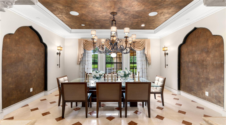 An Exquisite Formal Dining Room Is Distinguished By A Dramatic Statement Chandelier And Custom Architectural Detailing, An Elegant Setting For Memorable Gatherings.