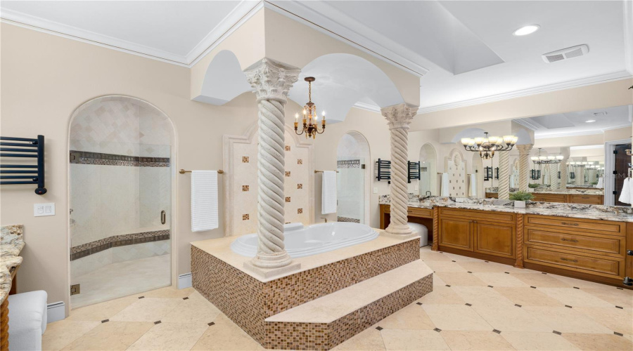 The Spa-Inspired Primary Bath Makes A Dramatic Statement With An Elevated Jacuzzi Soaking Tub, Sculptural Columns, Extensive Cabinetry And Dual Vanity Areas.