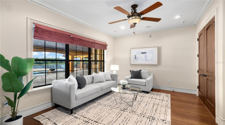 Bathed In Natural Light, This Private Sitting Room Offers A Tranquil Retreat Enhanced By Hardwood Flooring And Elegant Architectural Proportions.
