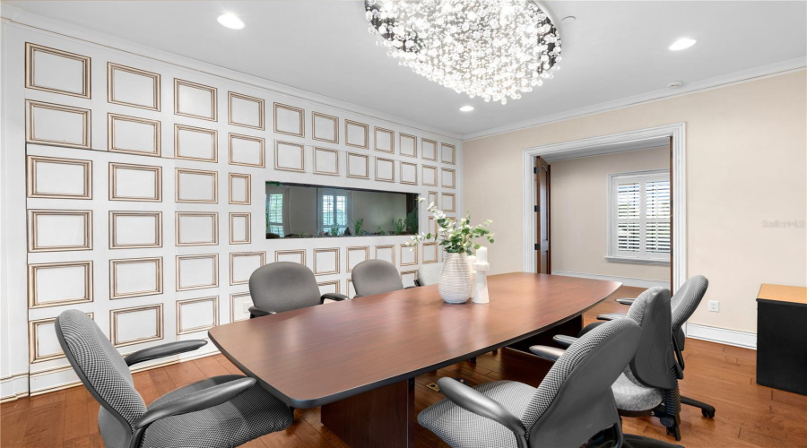 An Impressive Dedicated Boardroom With Statement Chandelier, Freshwater Fish Tank And Substantial Conference Table Underscores The Rare Executive Capabilities Of This Lake Mary Estate.