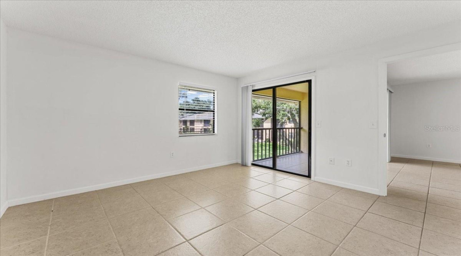 Primary Bedroom With Slider To Screened Porch Balcony