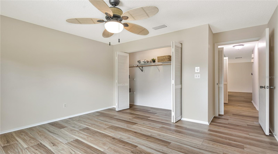 Guest Bedroom With Large Closet And Extra Shelves And Lighting