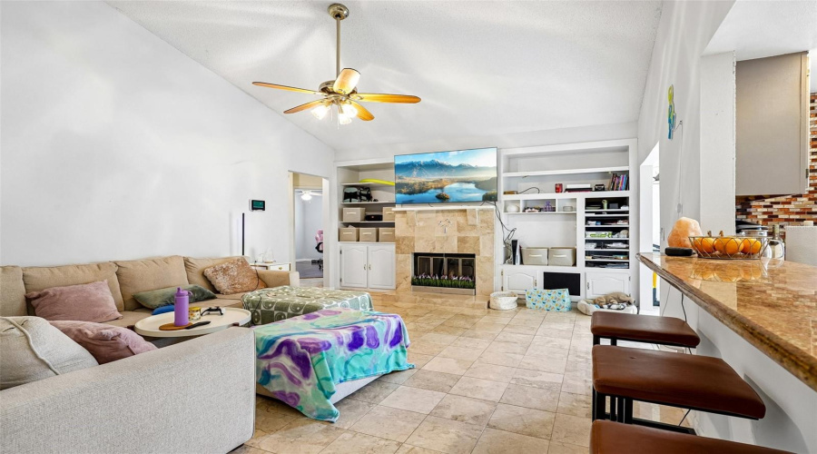 Living Room With Fireplace And Ceiling Fan