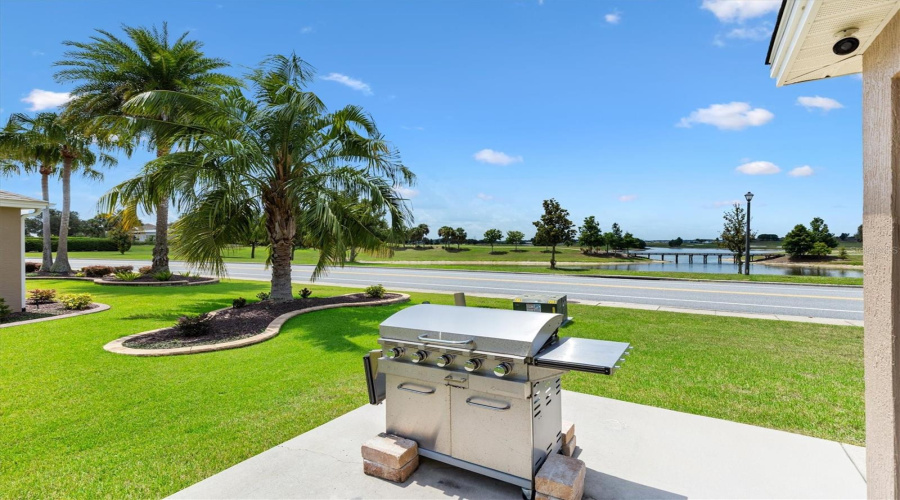 Grill Patio Next To Enclosed Lanai Looking Toward View Of Golf Course And Water View