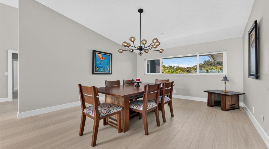 Open And Airy Dining Room Ideal For Seamless Entertaining And Family Gatherings.