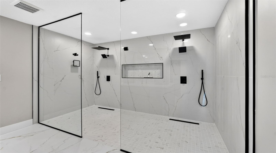 Oversized Walk-In Shower With Seamless Glass Enclosure Creating A Spa-Like Experience