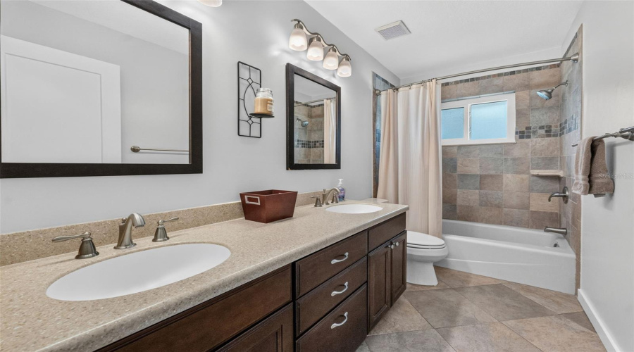 Hall Bathroom Featuring A Large Double Vanity, Perfect For Family Use And Morning Routines.