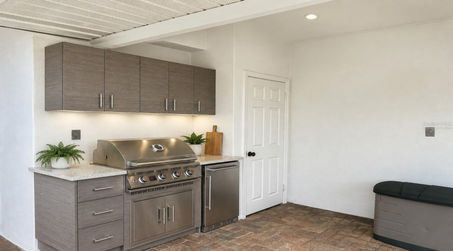 Virtually Staged Rendering Of Outdoor Kitchen Set Up Where The Wall Has Plumbing For Gas And Electrical.