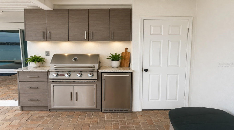 Virtually Staged Rendering Of Outdoor Kitchen Set Up Where The Wall Has Plumbing For Gas And Electrical.