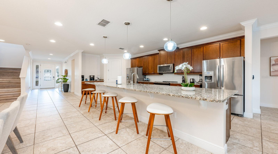 At The Heart Of The Home, The Updated Kitchen Is Both Stylish And Functional, Featuring 42-Inch Cabinetry, Granite Countertops, Stainless Steel Appliances, A Tile Backsplash, A Spacious Closet Pantry, And An Oversized Breakfast Bar That Comfortably Seats A Crowd.