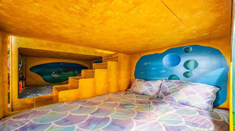 Dive Under The Sea With Ariel In A Stunning Ocean-Inspired Room Featuring Hand-Painted Murals, Coral Accents, And A Whimsical Sandcastle Bed.