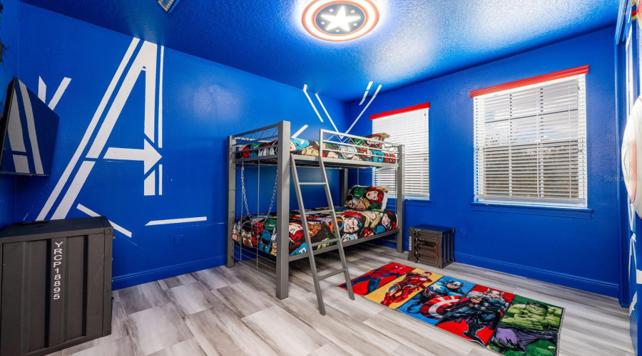 Unleash Superhero Adventures In The Vibrant Avengers-Themed Room Complete With Bold Murals And Immersive Design.
