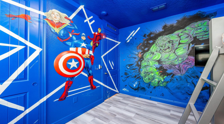 Unleash Superhero Adventures In The Vibrant Avengers-Themed Room Complete With Bold Murals And Immersive Design.