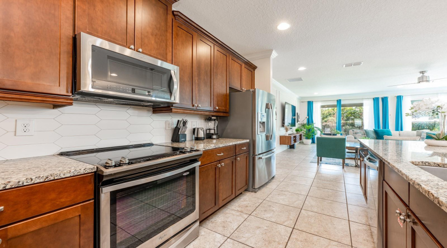 At The Heart Of The Home, The Updated Kitchen Is Both Stylish And Functional, Featuring 42-Inch Cabinetry, Granite Countertops, Stainless Steel Appliances, A Tile Backsplash, A Spacious Closet Pantry, And An Oversized Breakfast Bar That Comfortably Seats A Crowd.