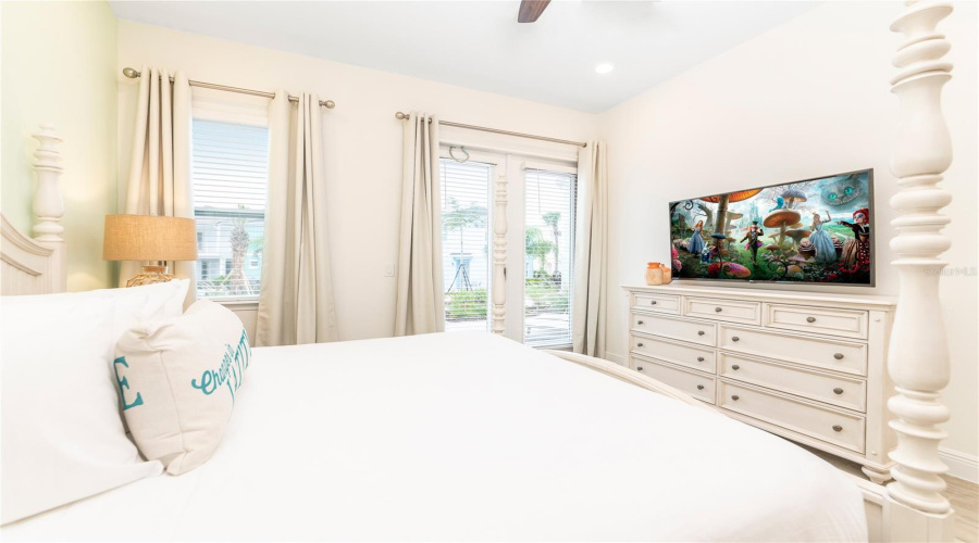 Bright Primary Bedroom With Coastal Décor And Large Windows In Kissimmee Vacation Home
