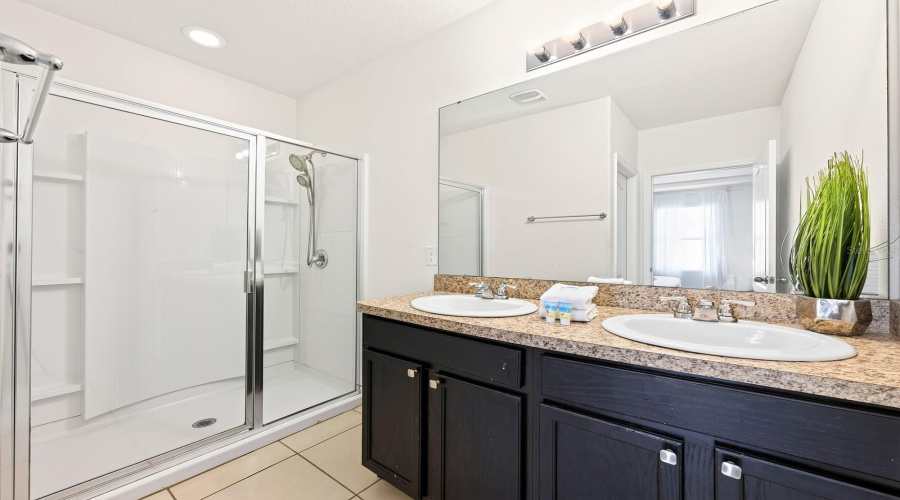 The Private Primary En-Suite Bath Features Dual Sinks, A Step-In Shower And Private Water Closet.