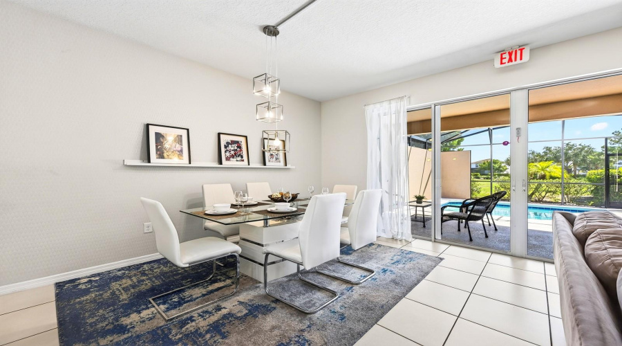 The Dining Area Sits Just Off The Kitchen And Offers Direct Access Through Sliding Glass Doors To The Outdoor Living Space.