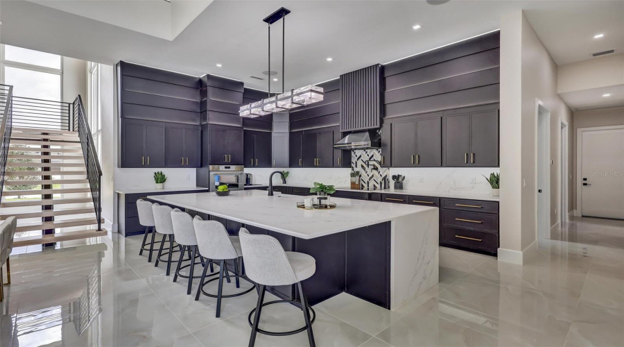 Designer Kitchen With Substantial Quartz Island And Generous Seating