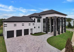 Commanding corner-lot residence in prestigious Eagle Estates at Reunion Resort