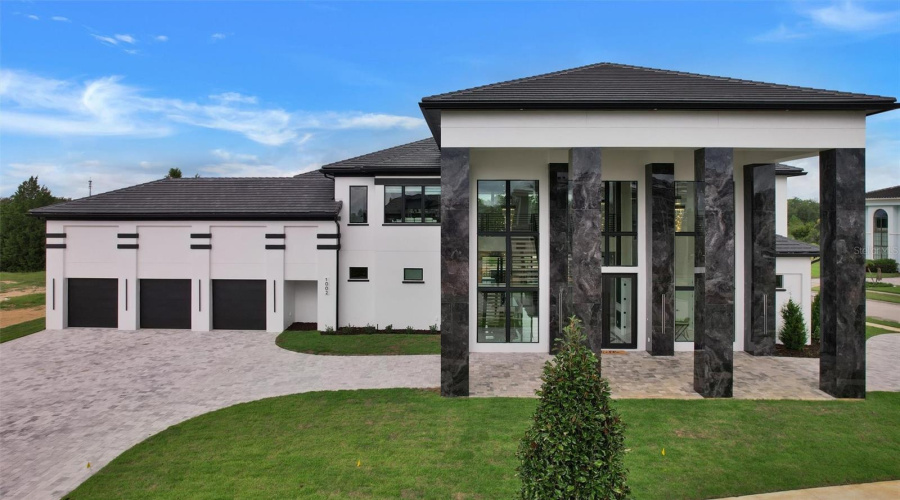 Grand Porte-Cochère Arrival With Three-Car Garage And Sweeping Circular Drive