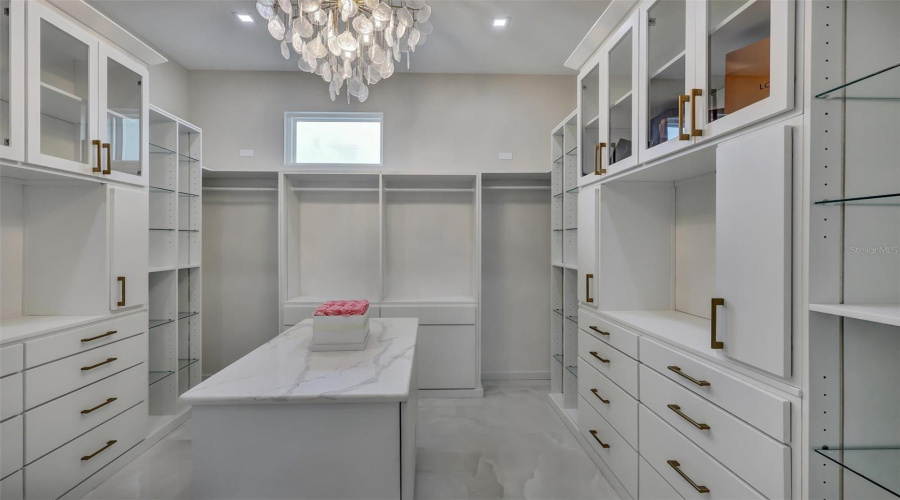 Custom Primary Dressing Room With Extensive Built-In Cabinetry And Center Island