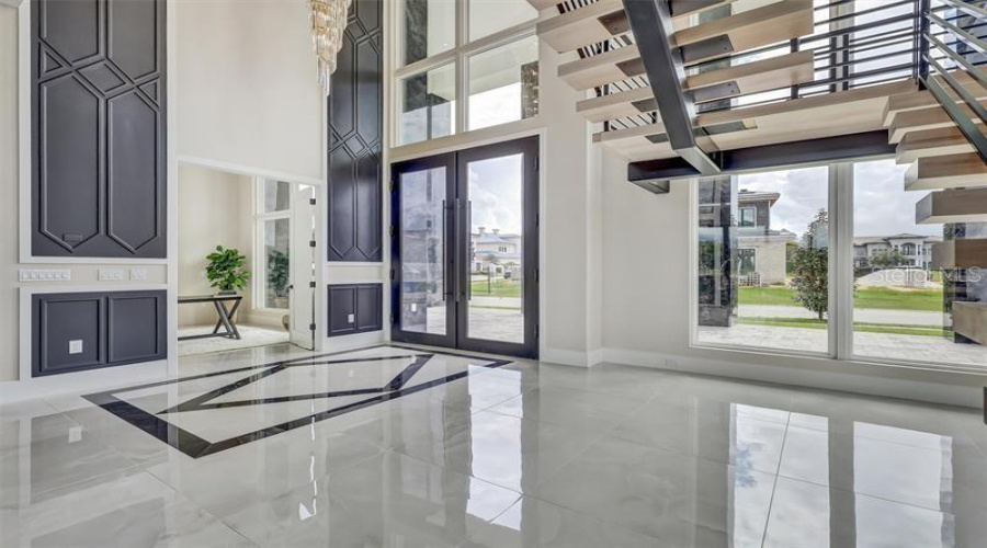 Dramatic Entry Framed By The Floating Staircase And Two-Story Windows