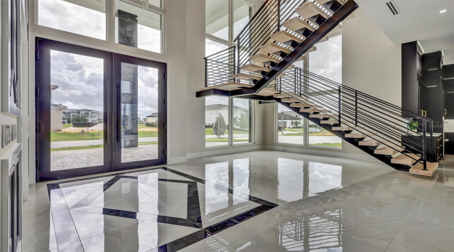 Impressive Foyer With Soaring Glass And Architectural Floating Staircase