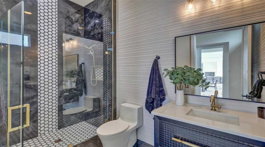 Stylish Pool Bath Conveniently Positioned For Outdoor Living. Shower Tiled To The Ceiling