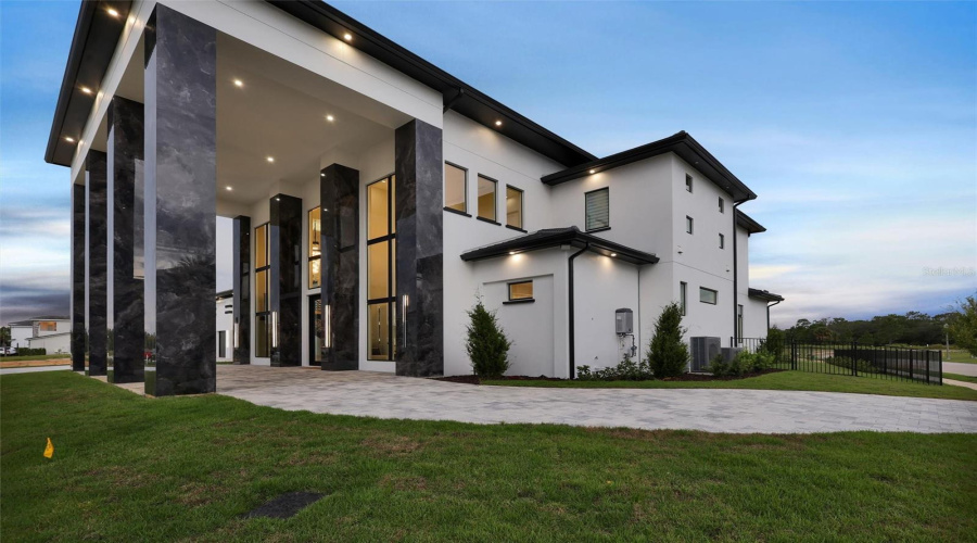 Architectural Columns, Floor-To-Ceiling Glass And Designer Lighting Make A Dramatic Statement