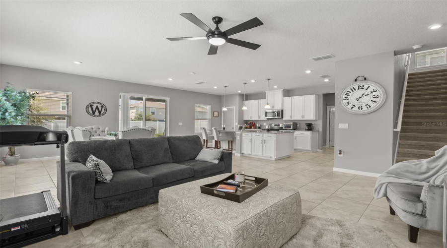 View From Family Room Showing Service Island, Kitchen, And Staircase To Second Floor.