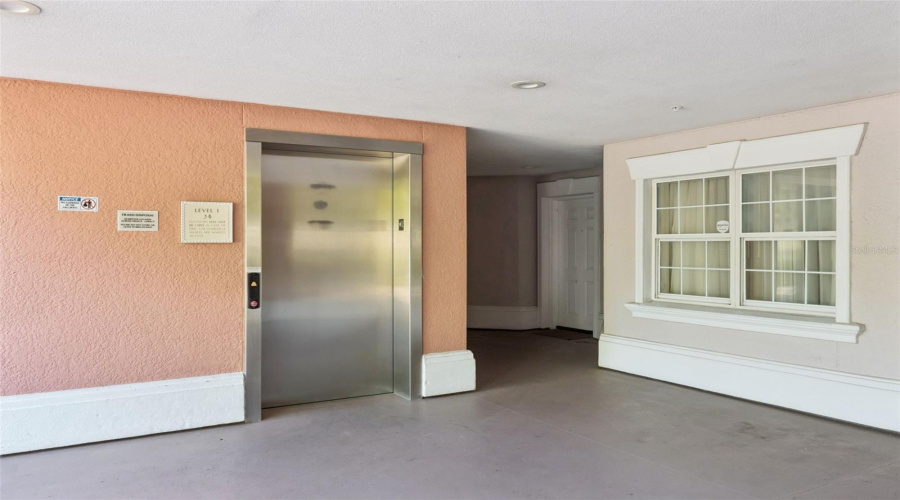 Elevator Lobby: Clean, Covered Ground-Floor Elevator Foyer Offering Convenient Access To All Floors.