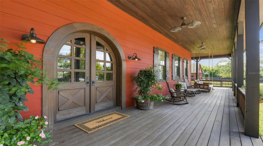 Double Front Doors And Wrap-Around Porch