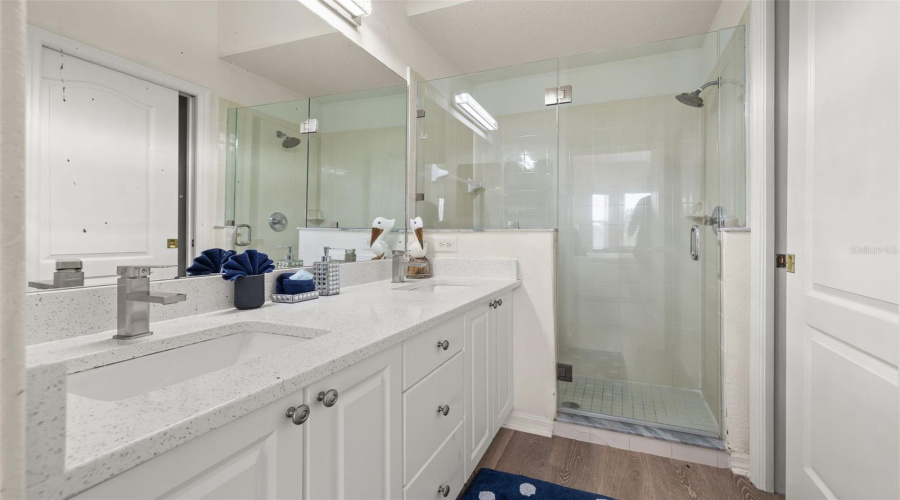 Primary Bathroom With Walk In Shower And Dual Vanities