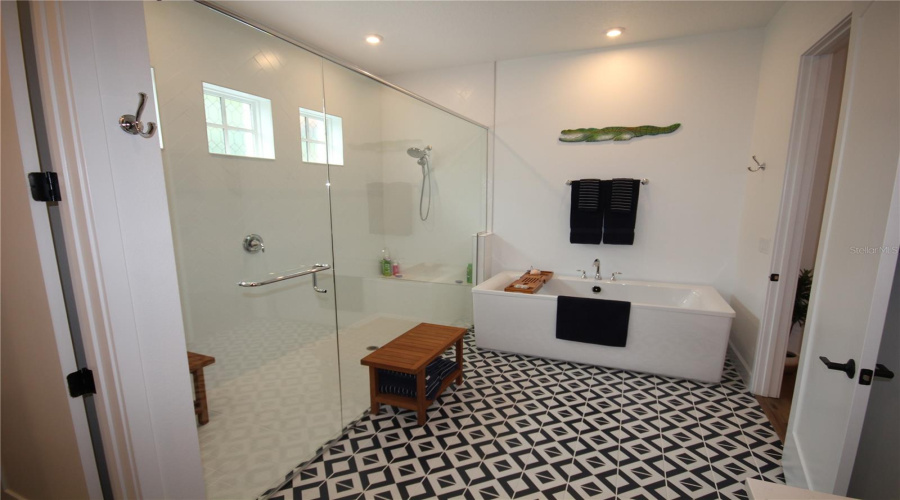Walk-In Shower With Built-In Bench And Freestanding Soaking Tub