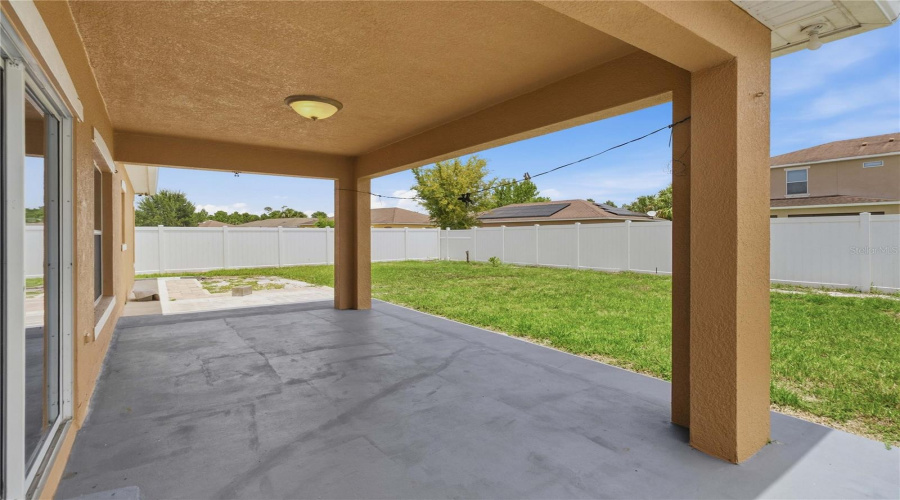 Covered Lanai From Sliding Door To Back Yard. Fully Fenced In