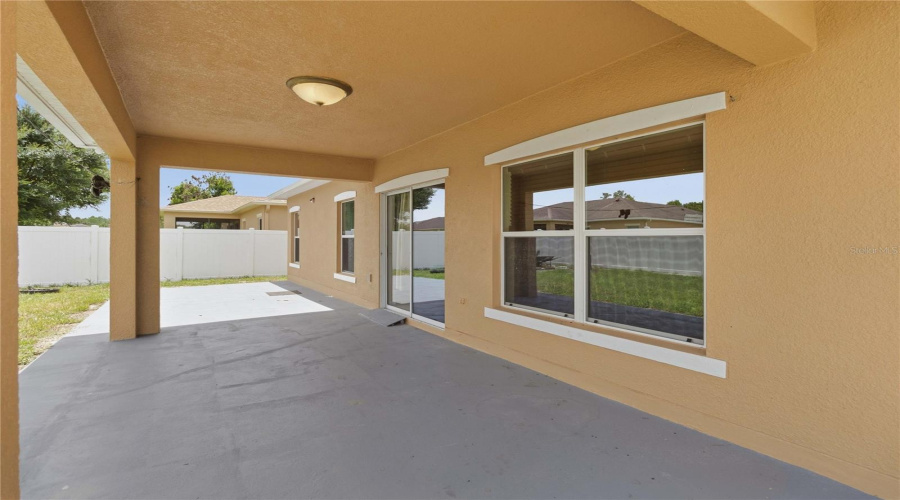 Covered Lanai From Sliding Door To Back Yard. Fully Fenced In